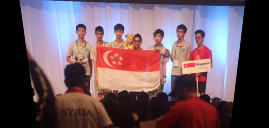 A group of boys holding a flag

Description automatically generated
